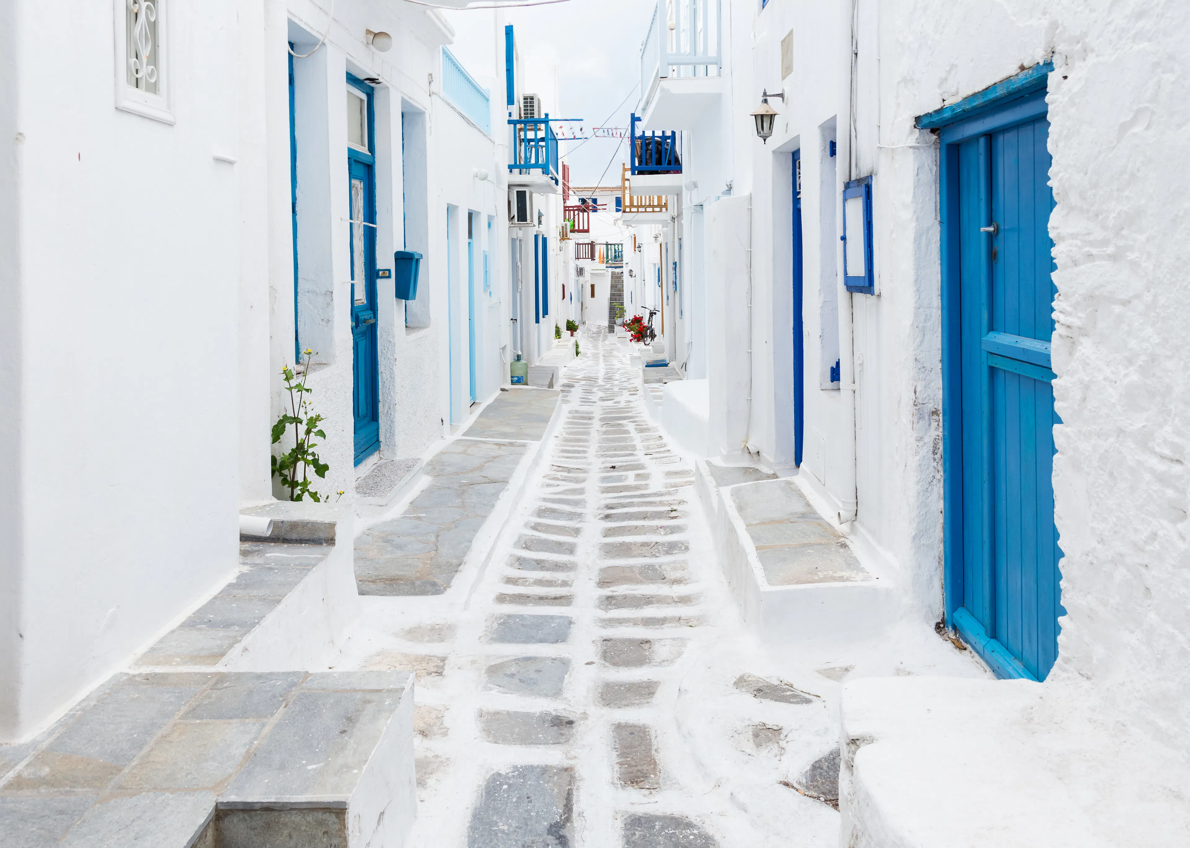 White and blue buildings line an ornate passageway