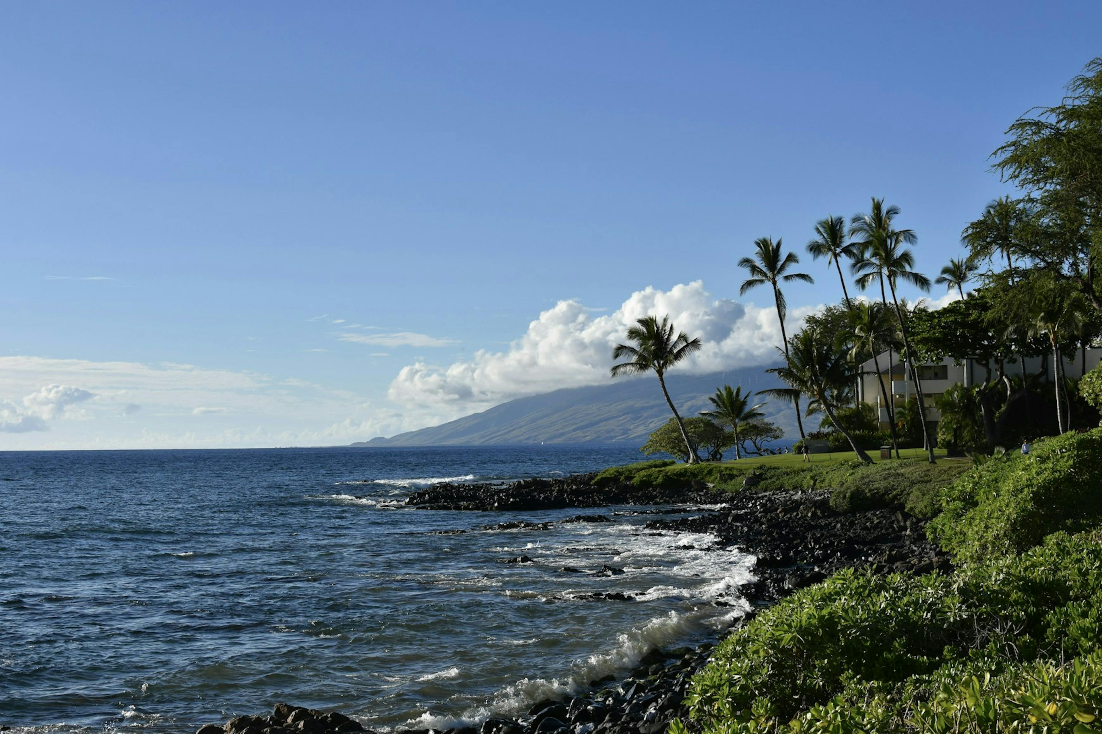 Jet flying over the coast of Maui at sunset