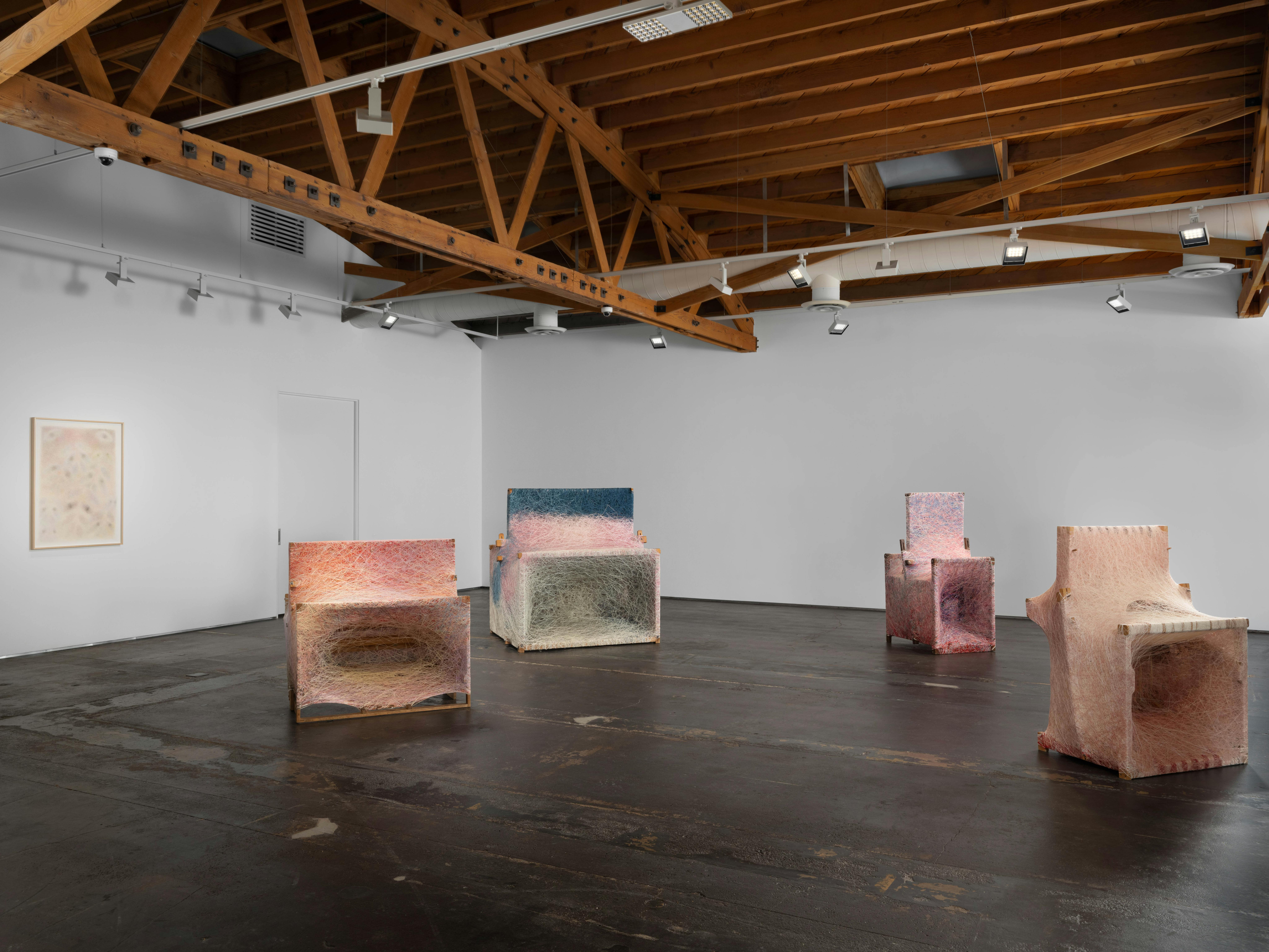 Installation view of the Dressed Loom series by Sheng Lor from the exhibition Interstitial at Gallery Sonder, showing multiple woven sculptural works arranged throughout the gallery space.