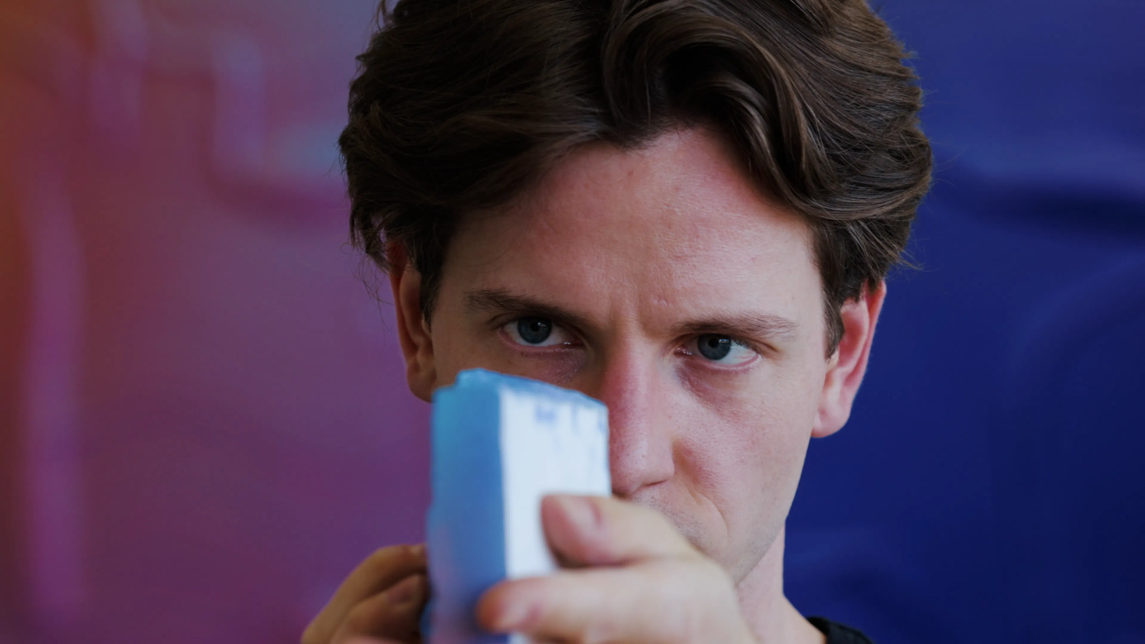 Ruben Benjamin examining pigments used in the creation of his sculptural paintings.