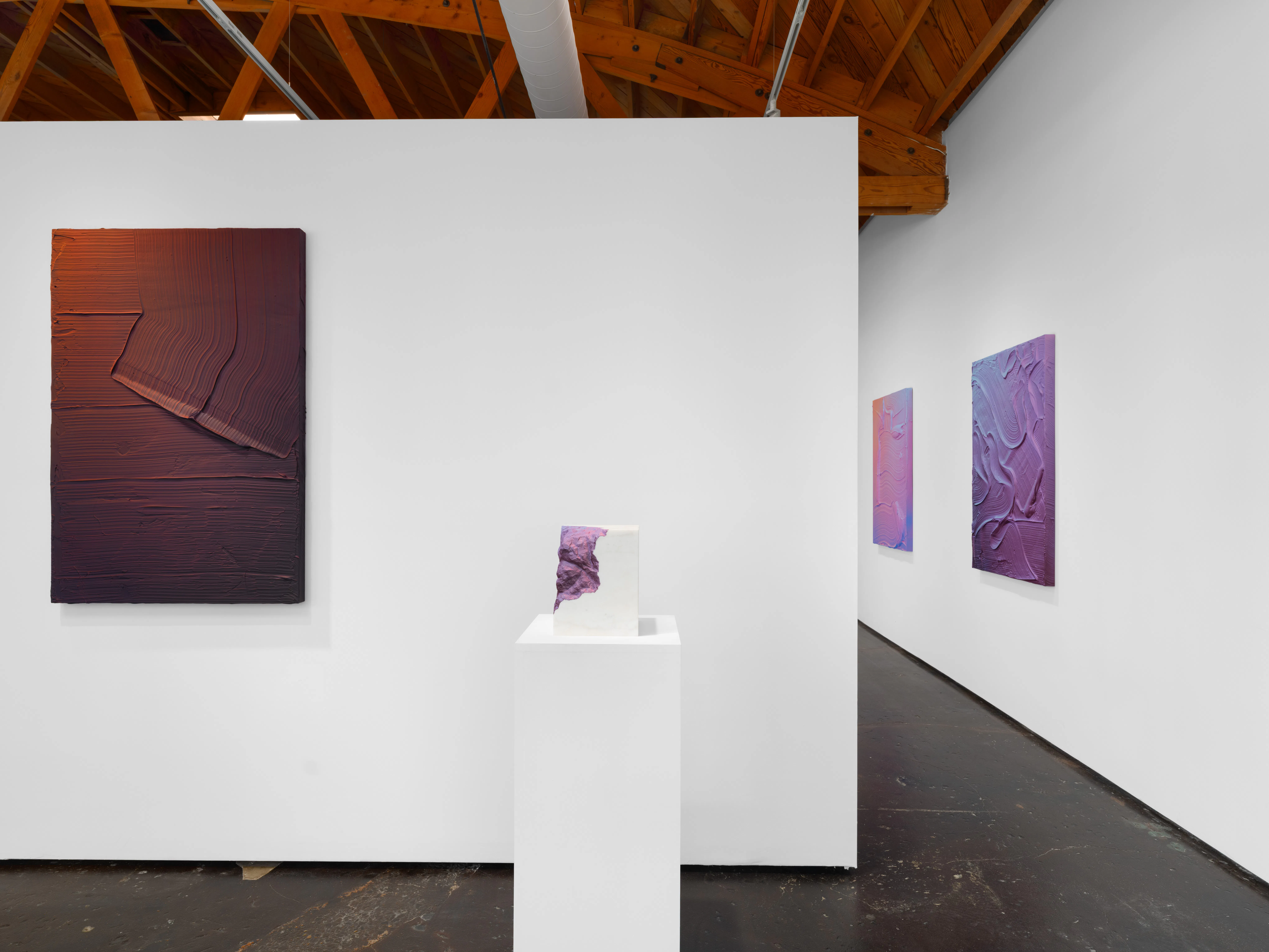 Ruben Benjamin, After The Dust Settles, 2026 — installation view at Gallery Sonder showing a large earth-toned painting alongside a pedestal-mounted sculpture in the foreground, with additional works visible extending into an adjacent gallery space, emphasizing spatial flow and continuity. Gallery Sonder, Orange County.