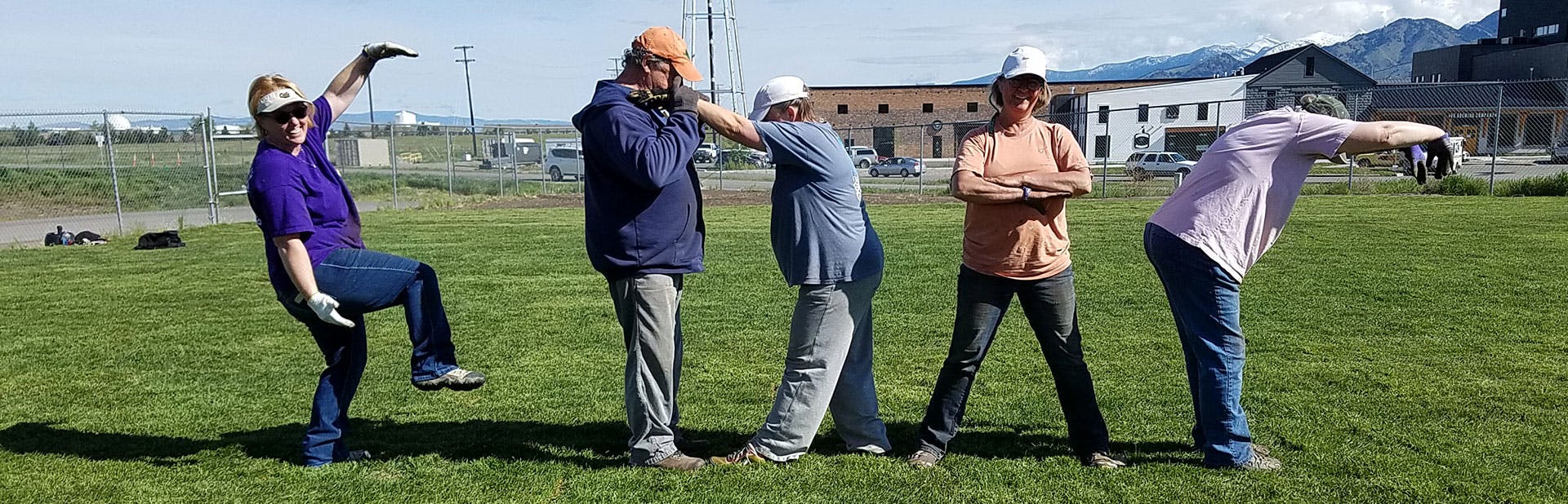 Members spelling GDAC with their bodies in a field.