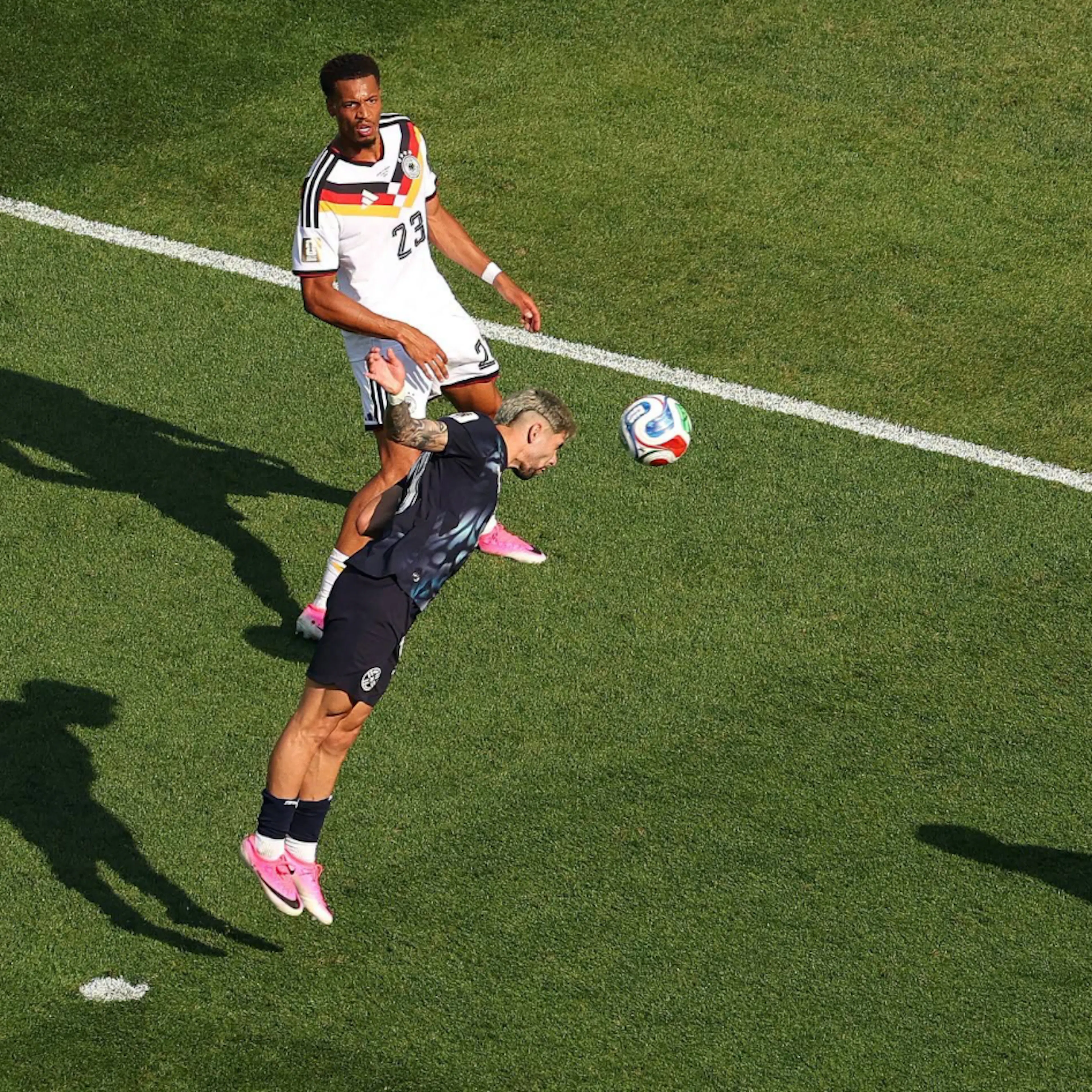 An aerial duel at the halfway line during a knockout match