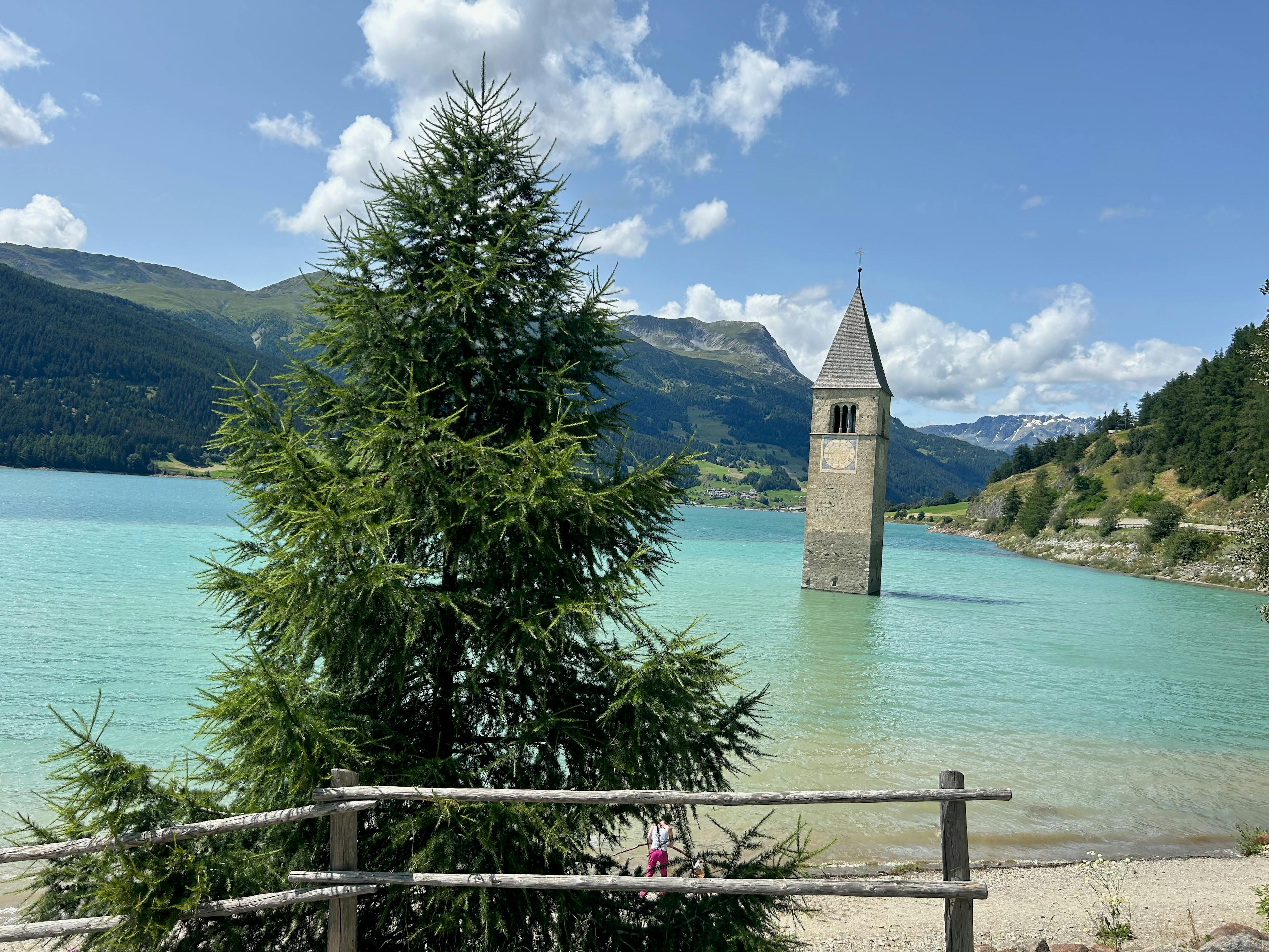 A church steeple submerged in a lake