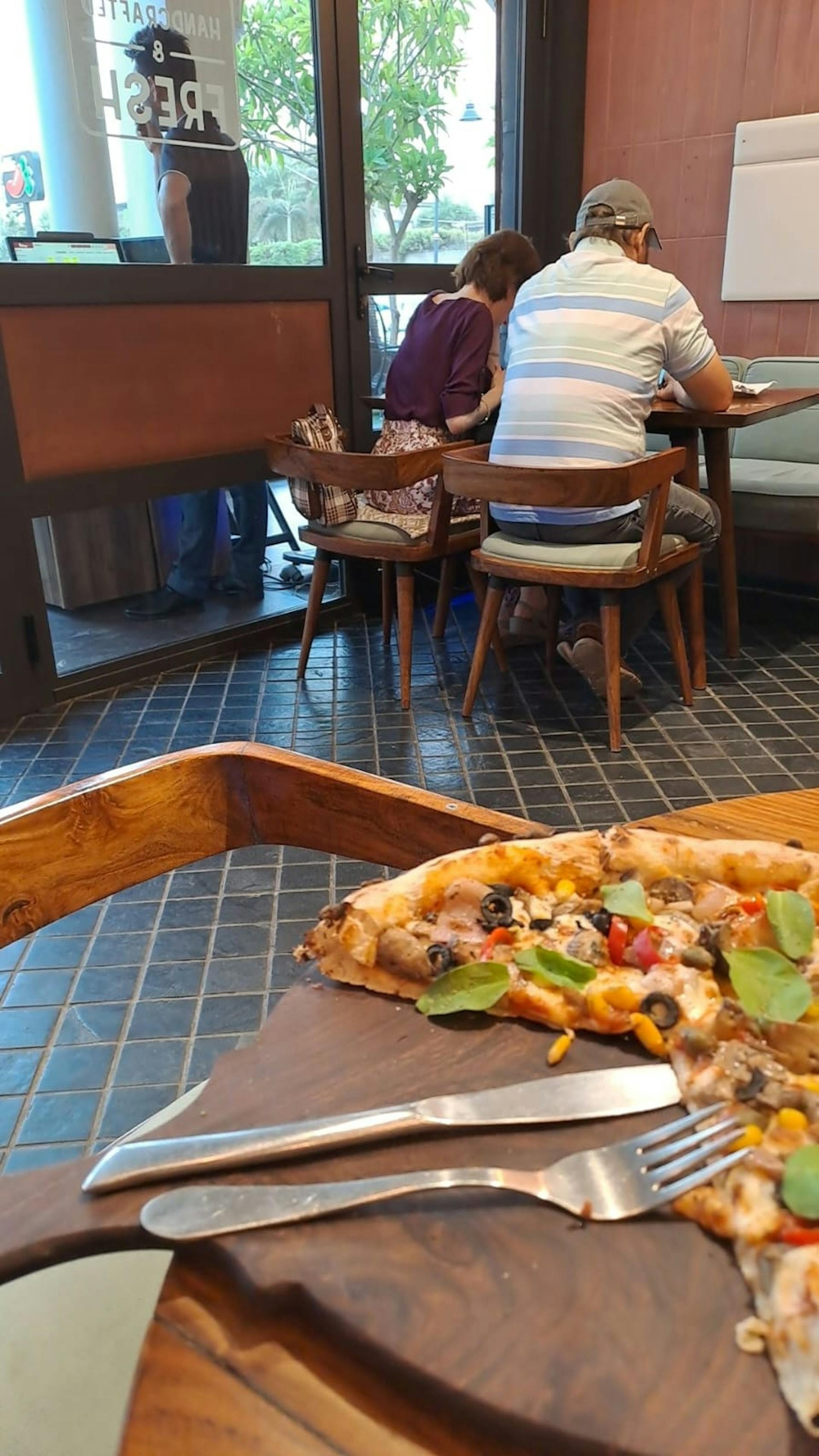 image of a slice of pizza in a restaurant