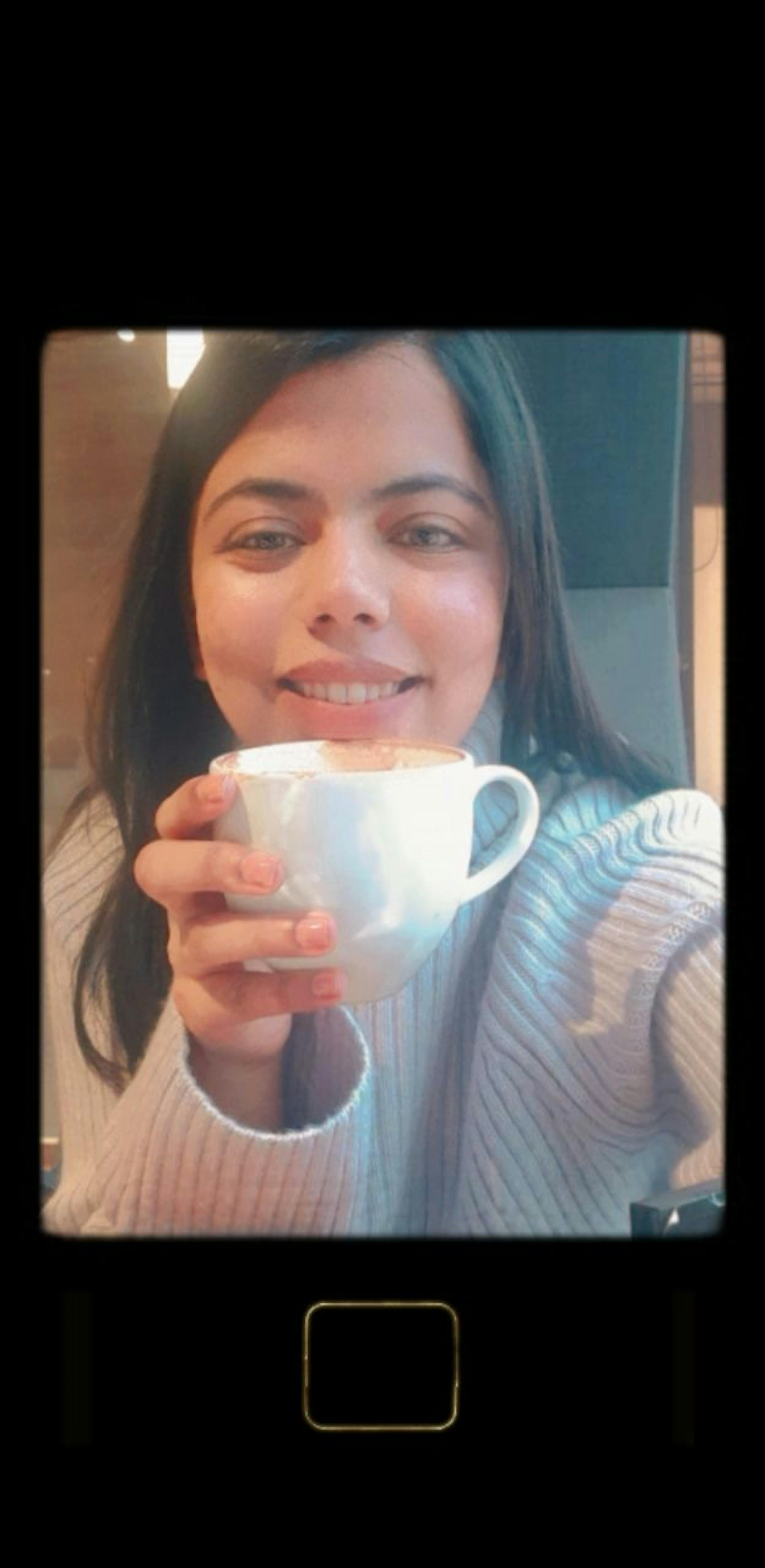 picture of gayatri drinking a cup of coffeee