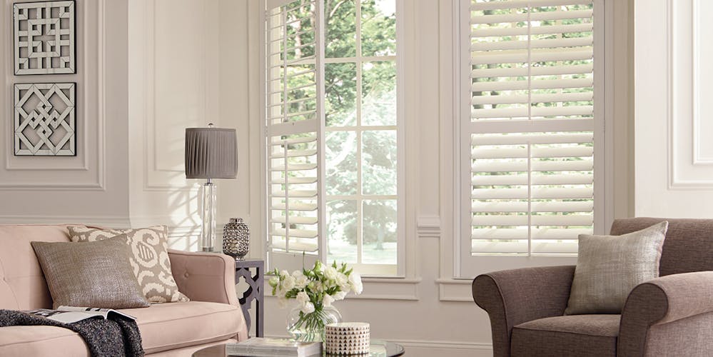 open off white shutters facing the front of a house from the living room
