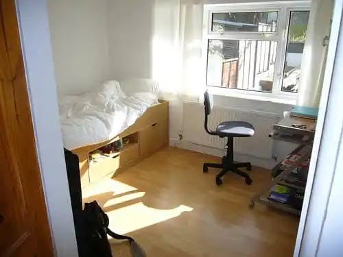 Sunny dorm room with built in bed
