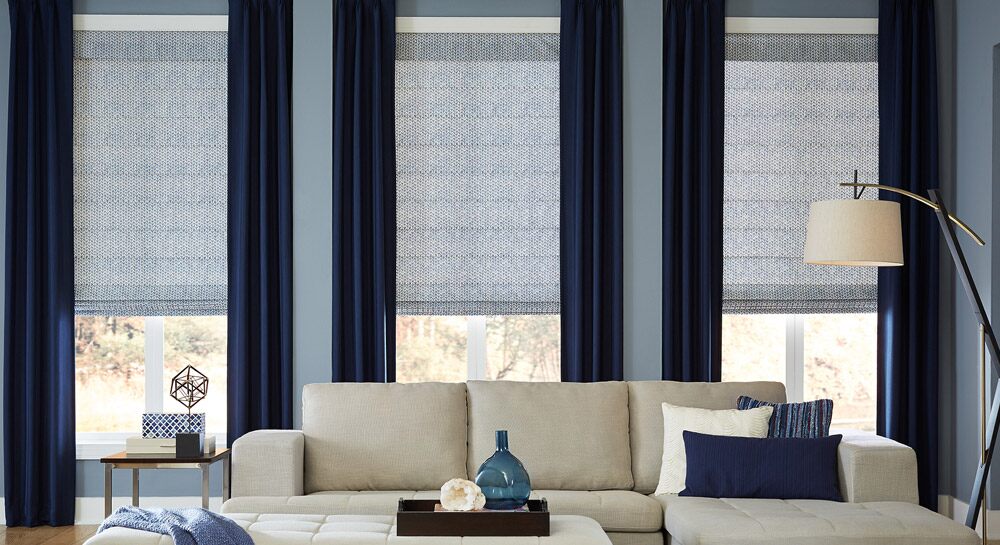 Blue curtains alongside light blue shades in a blue accented living room