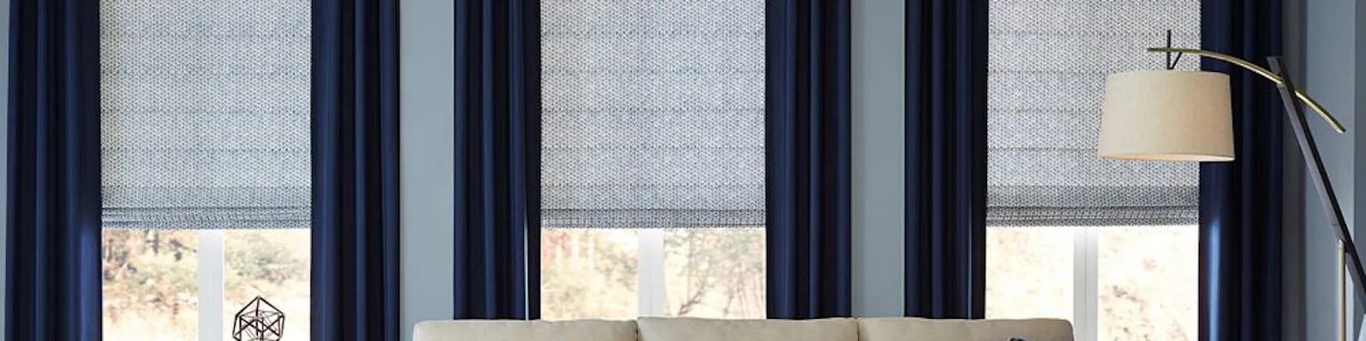 Blue curtains alongside light blue shades in a blue accented living room