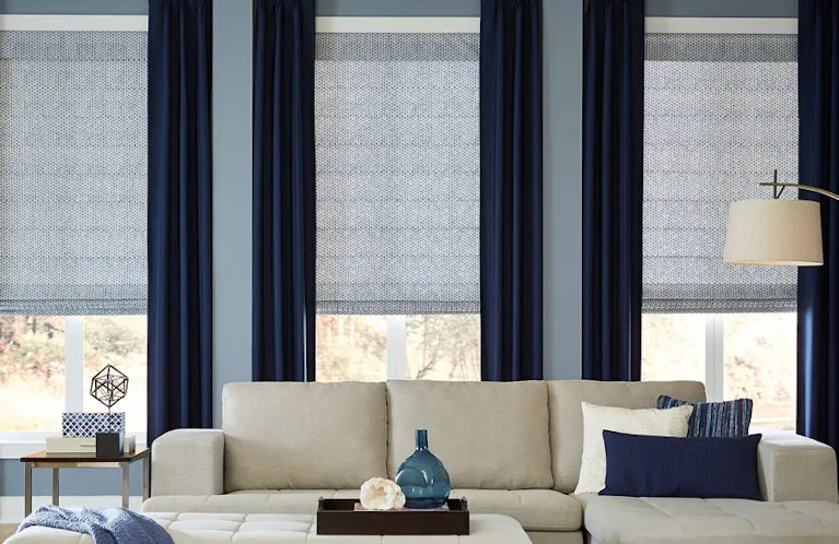 Blue curtains alongside light blue shades in a blue accented living room