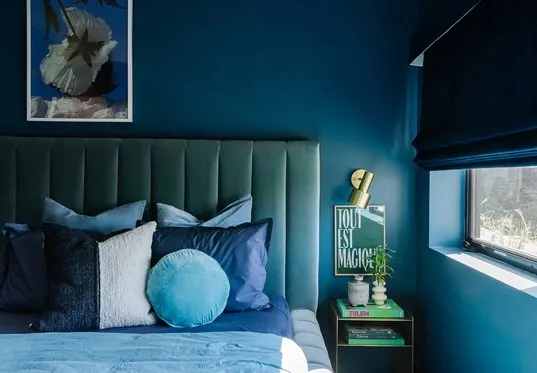 roman shade with blackout option in blue bedroom