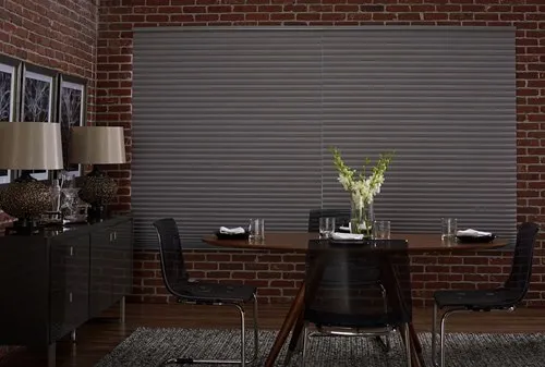 large backout cellular shade in brick dining area