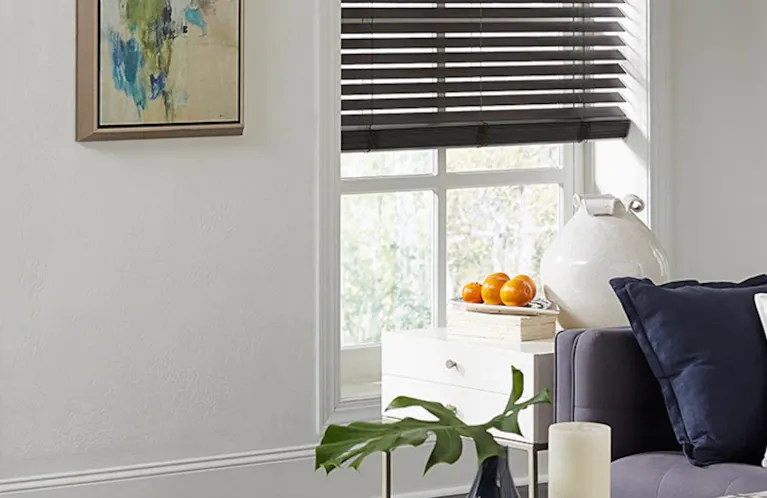 dark wood blinds against a white wall in a bright living room