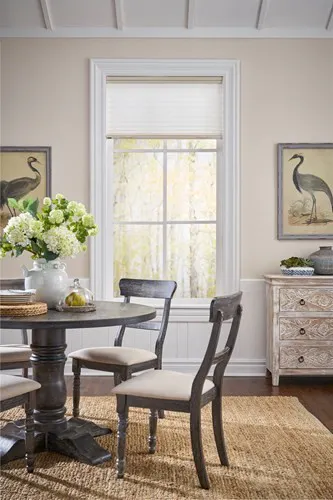 light filtering cellular shades open in dining area