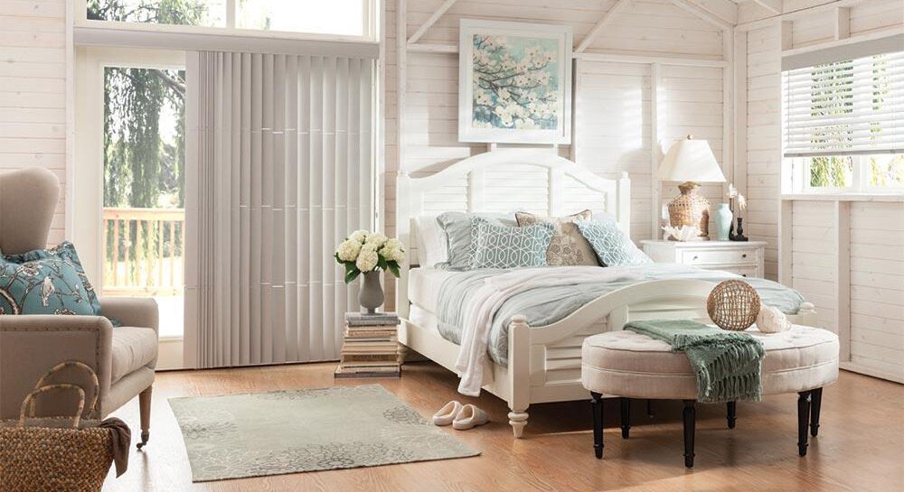 White faux wood blinds and vertical blinds in a brightly lit bedroom