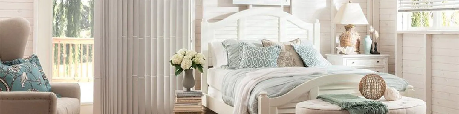 White faux wood blinds and vertical blinds in a brightly lit bedroom
