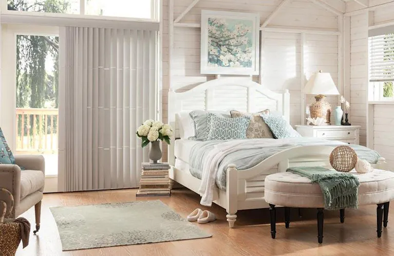 White faux wood blinds and vertical blinds in a brightly lit bedroom