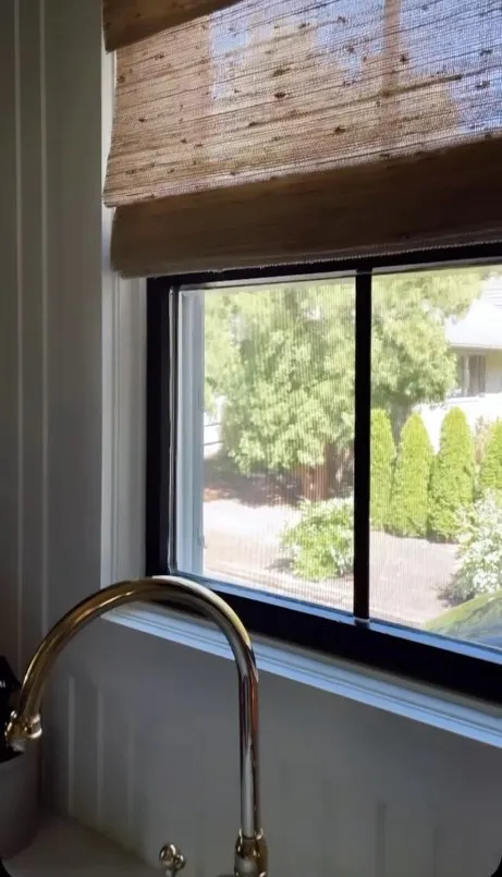 window above sink with woven wood shades professionally installed