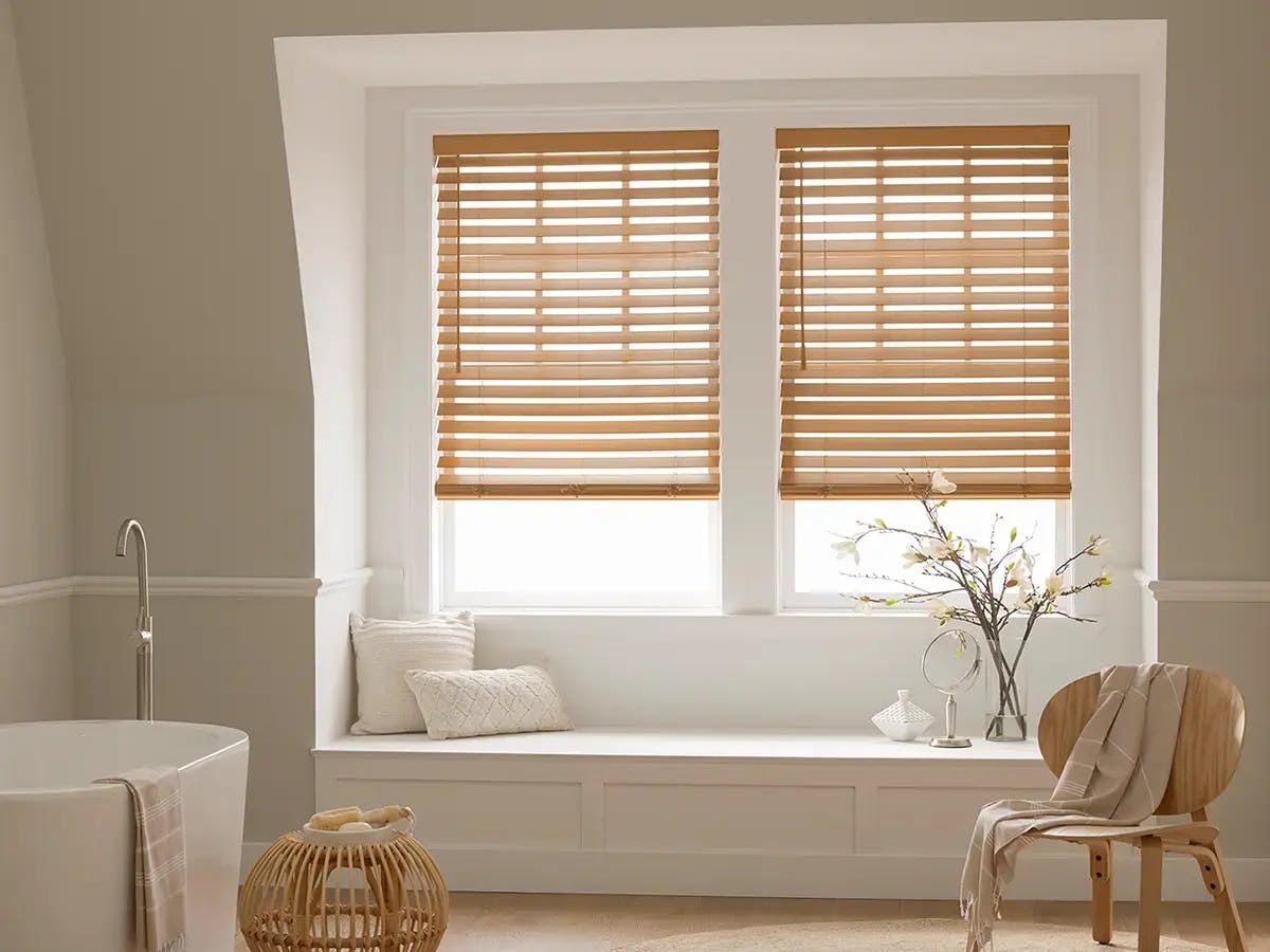 Bathroom features brown wood blinds.
