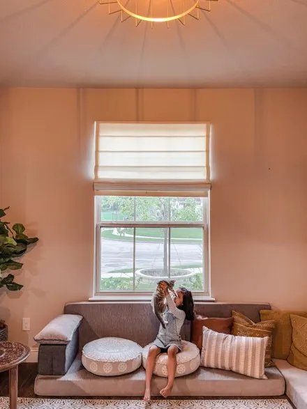 premium roller shades woman on couch