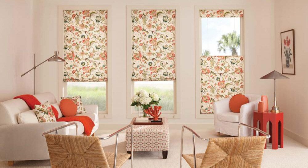 Shades with an orange and peach floral pattern in a living room