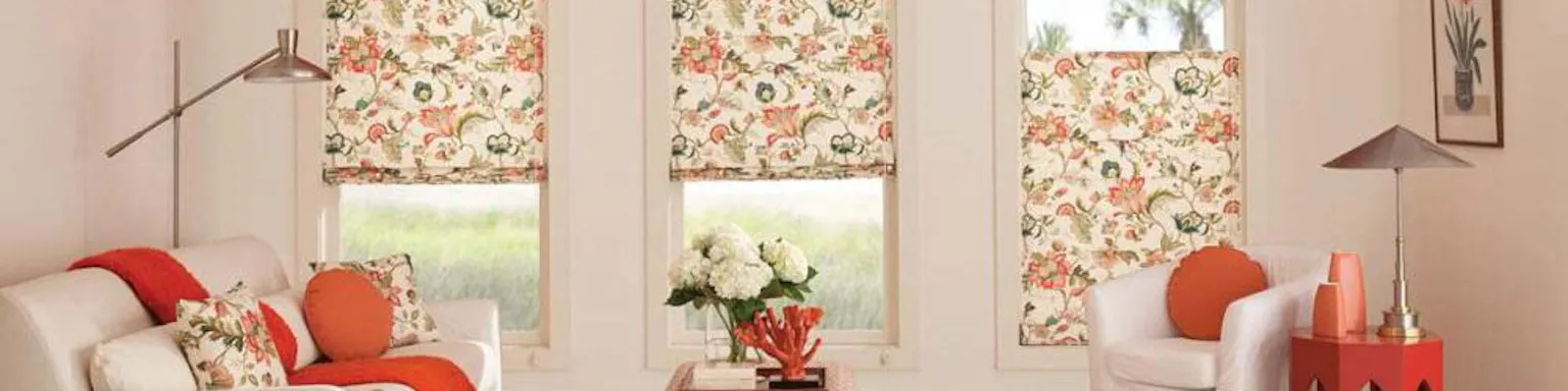 Shades with an orange and peach floral pattern in a living room