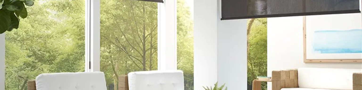 coolaroo brand outdoor shades in dark grey on a white exterior patio