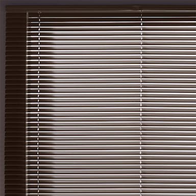 Bedroom window with classic aluminum mini blinds offering simple and affordable light control