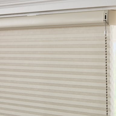 Modern living room with light-filtering cellular shades that provide insulation and a clean, minimalist look.