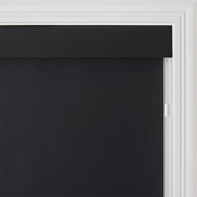 Bright modern room with sleek black roller shades offering smooth light control and privacy