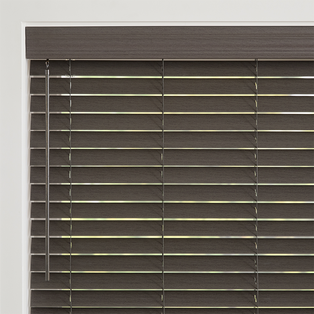 Cozy sitting area featuring durable faux wood blinds with rich texture and warm natural tones