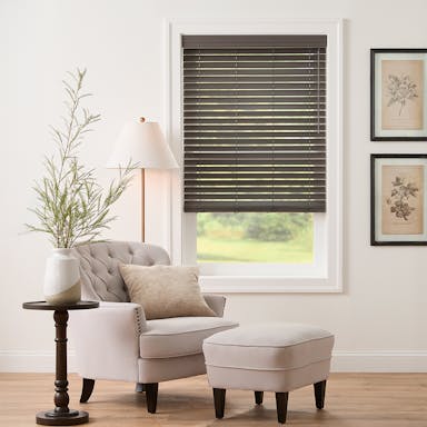 Cozy sitting area featuring durable faux wood blinds with rich texture and warm natural tones