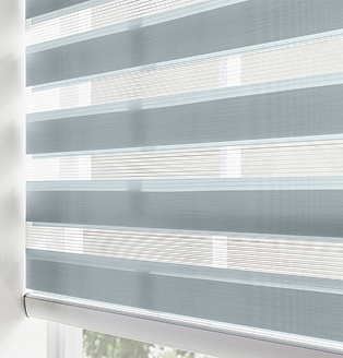 Window with soft blue zebra shades in a bright entryway, showing alternating sheer and solid bands for adjustable light control.