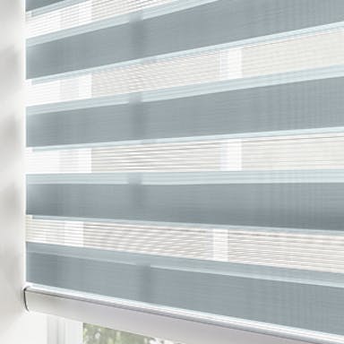 Window with soft blue zebra shades in a bright entryway, showing alternating sheer and solid bands for adjustable light control.