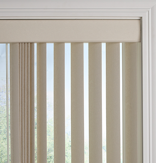 Neutral living space with beige vertical blinds on a tall window, styled with a wooden side table, green pillow, and potted plant