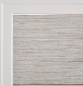 Elegant living space with soft gray Roman shades that add timeless style and sophistication.