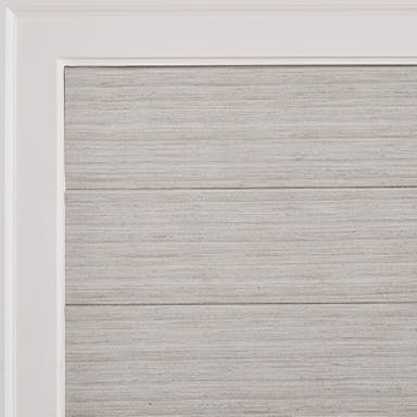 Elegant living space with soft gray Roman shades that add timeless style and sophistication.