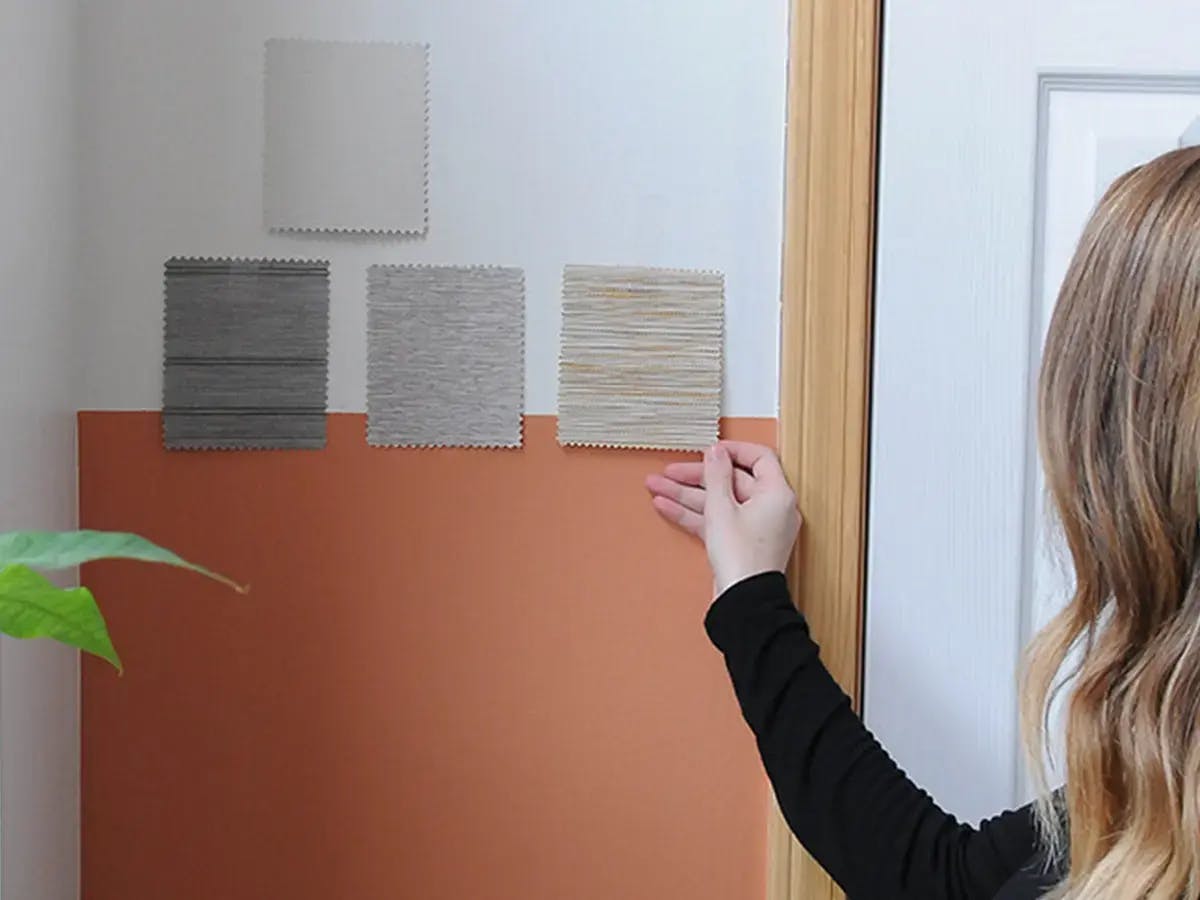 Woman looking at samples on a wall.