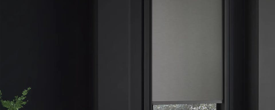 Grey roller shade on window