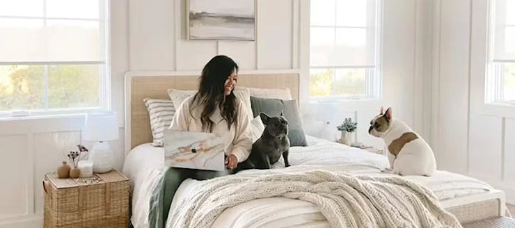 Woman with dogs on bed