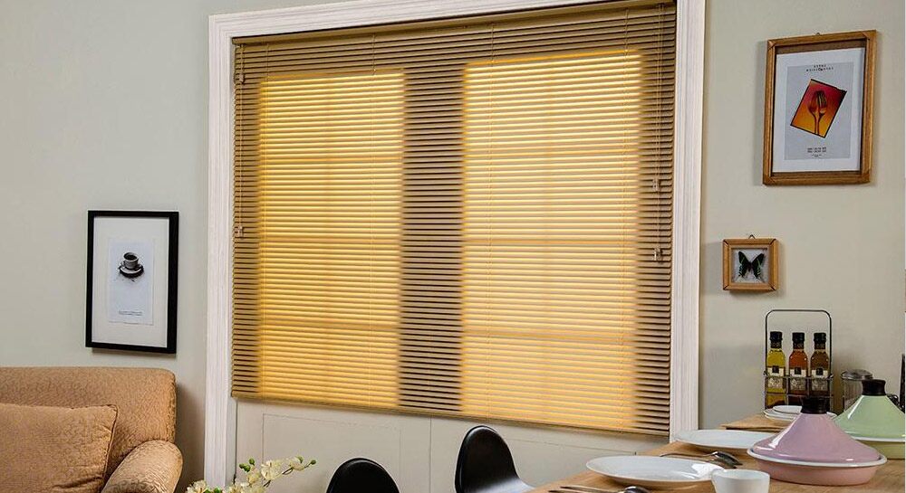 Yellow shades covering a window near a dining table