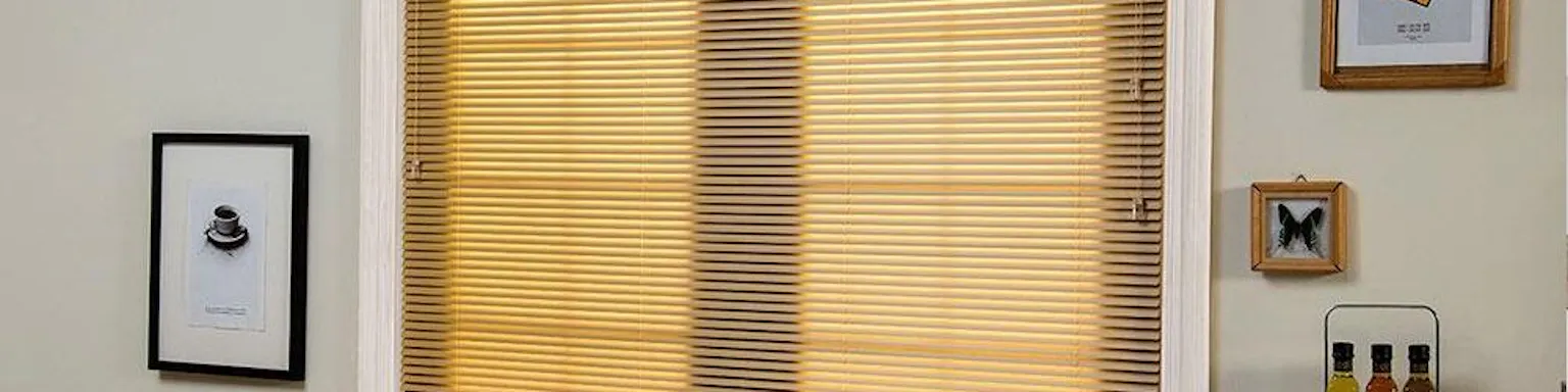 Yellow shades covering a window near a dining table