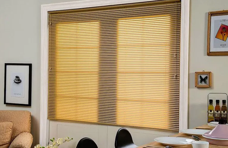 Yellow shades covering a window near a dining table