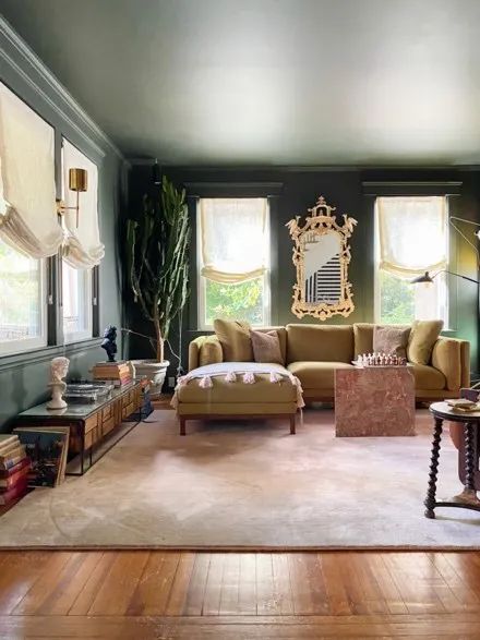 white roman shades in dark living room 