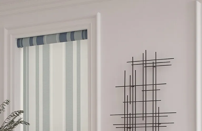 Striped roller shades with blue tones against an off-white wall