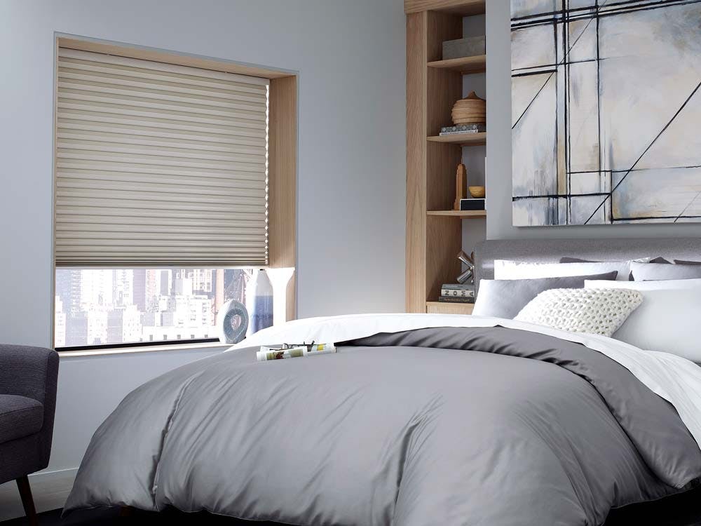 Soothing bedroom decor featuring grey tones and cellular shades