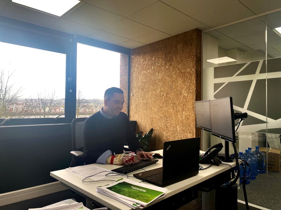 A photo of Phil sitting at a desk.