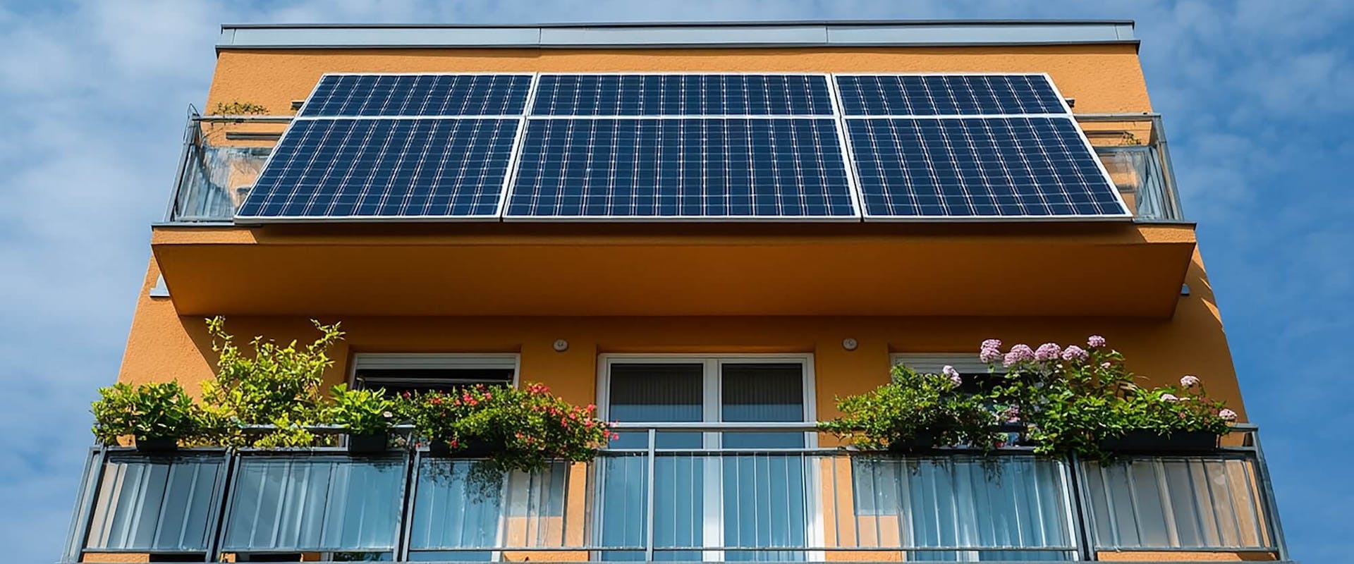 Solarmodule am Balkon eines orangefarbenen Mehrfamilienhauses Solarmodule am Balkon eines orangefarbenen Mehrfamilienhauses