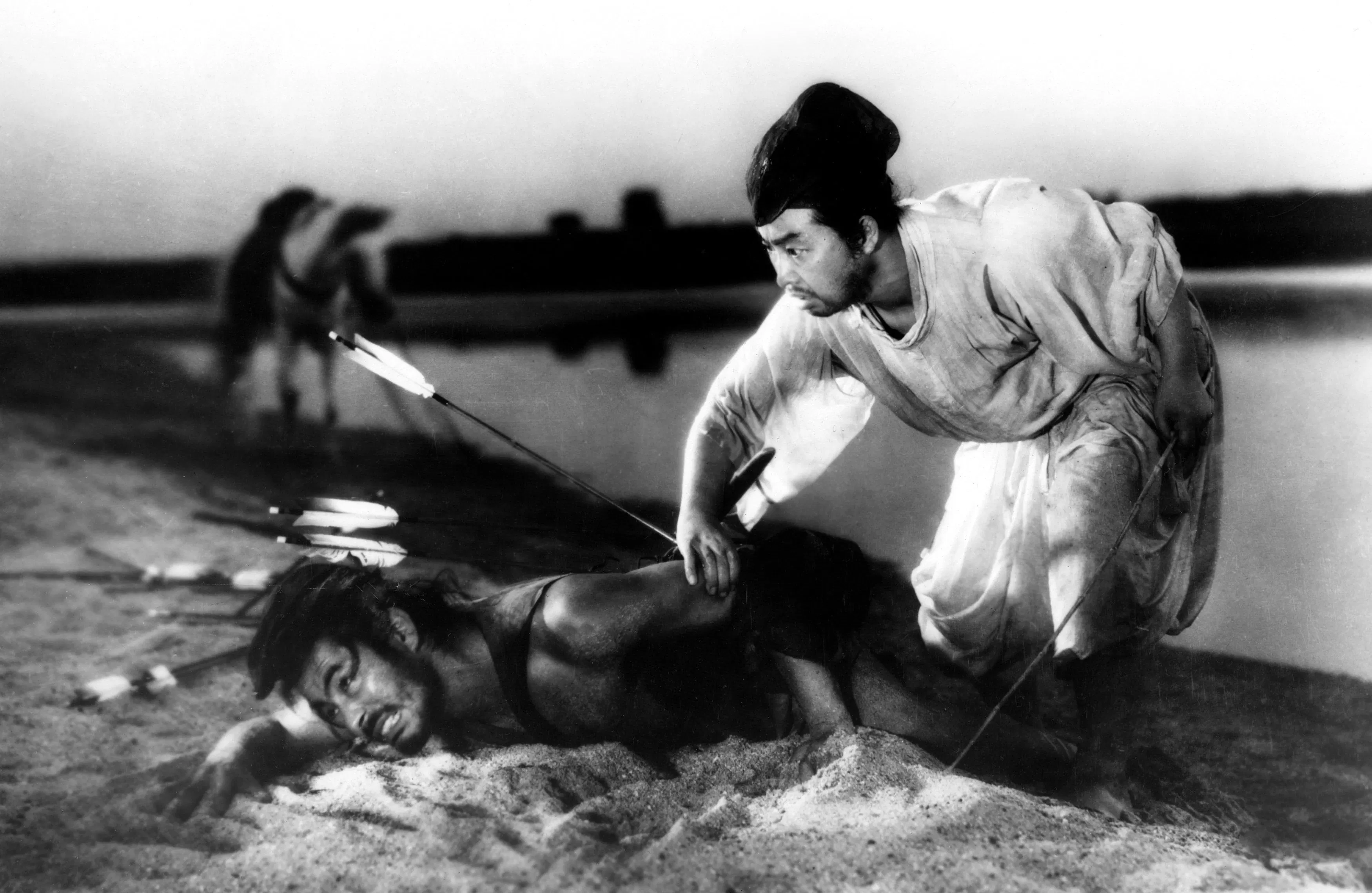 Toshiro Mifune and Daisuke Katō in Rashomon (1950). Daiei press photo, public domain, via Wikimedia Commons.